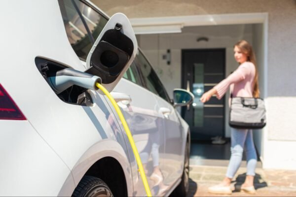 a person charging an ev battery at their home