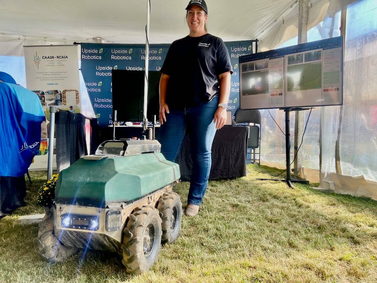 Tanya Franklin, of Upside Robotics, stands with one of the company’s fertilizer robots at Canada’s Outdoor Farm Show in 2025. Photo: John Greig