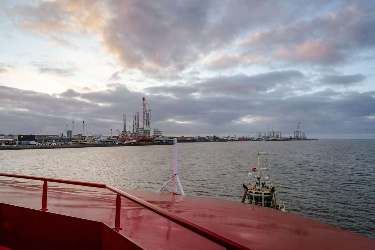 View from the Carbon Destroyer as the CO₂ carrier approaches the Port of Esbjerg, with harbour infrastructure and vessels visible across the water