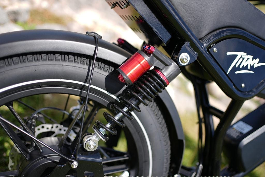 Heybike Titan Review: Street Legal, Built for Distance, and a Real Saturn Rival 3 Close-up of the Heybike Titan rear spring shock, 180mm rotor and fat tire