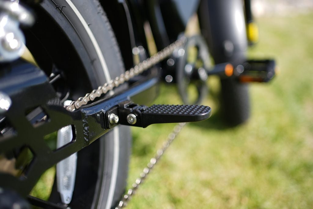 Heybike Titan Review: Street Legal, Built for Distance, and a Real Saturn Rival 7 Fold-out passenger foot peg on the Heybike Titan swingarm