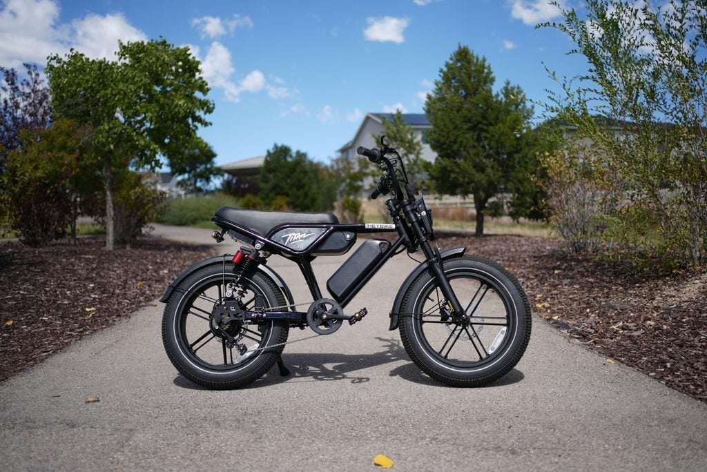 Heybike Titan Review: Street Legal, Built for Distance, and a Real Saturn Rival 1 Heybike Titan moped-style electric bike, side view on a paved path, RiderGuide test bike