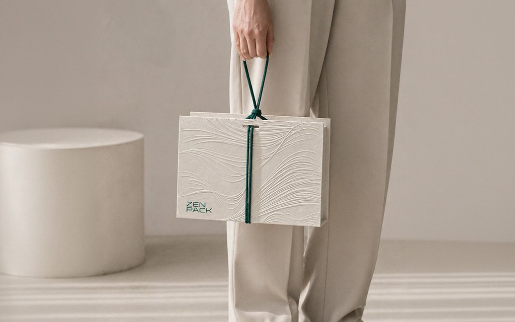 Zenpack Mid-Autumn Packaging Design featuring an embossed white gift box with green cord handles for 2026 PR gift set.