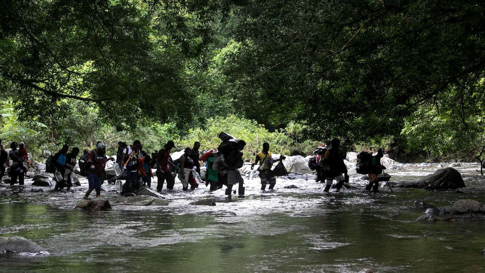 Several people seen crossing a river