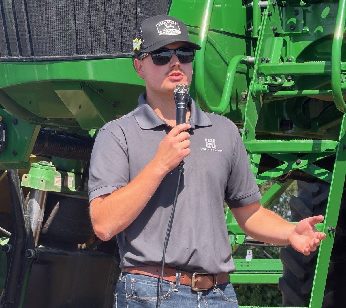 Matt McCallum from Huron Tractor talking in front of a sprayer. Photo: John Greig