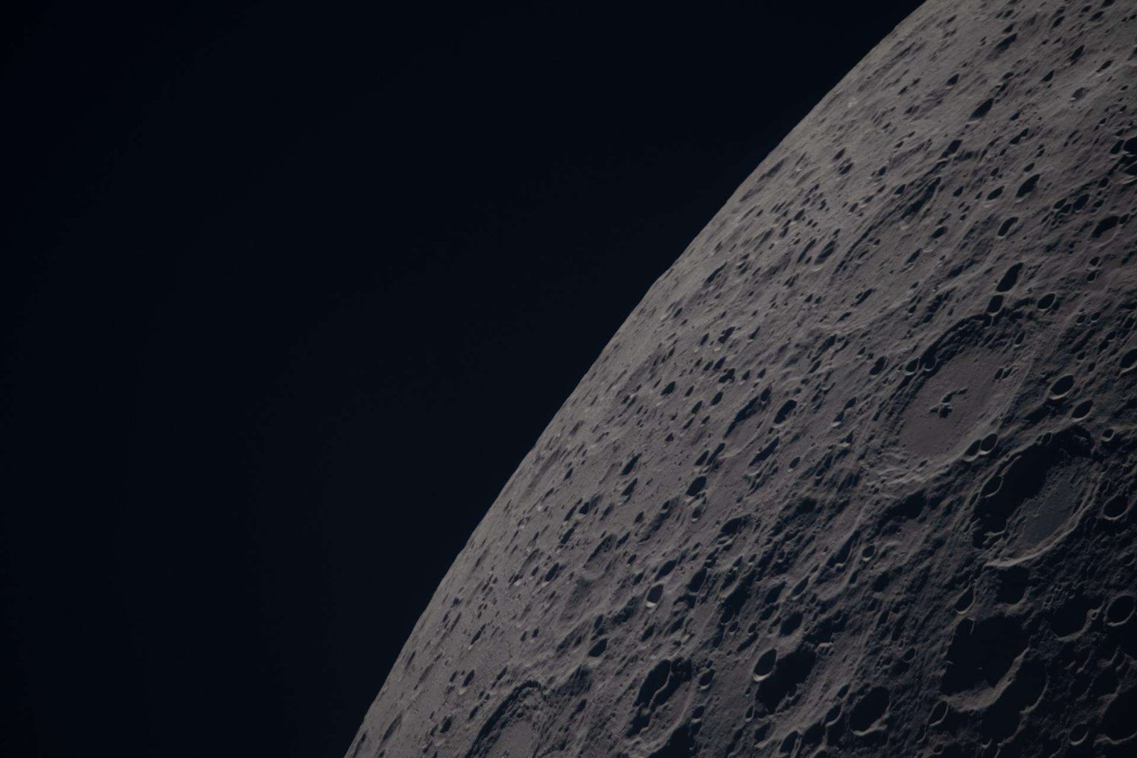 (April 6, 2026) – Poynting crater and Keeler crater are visible side by side in the lower right portion of this image of the Moon’s far side highlands. Poynting, positioned above, is a large impact crater with a well-defined rim and relatively smooth interior, indicative of material that has settled following the initial impact. Just below it, Keeler crater appears slightly smaller, with a sharply outlined rim and a more textured interior shaped by subsequent impacts and ejecta. Both features lie within the densely cratered far side highlands, preserving a record of ancient impacts that have shaped the lunar surface over billions of years.