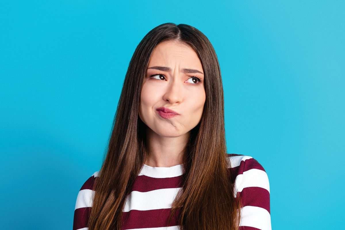 A young woman looks puzzled