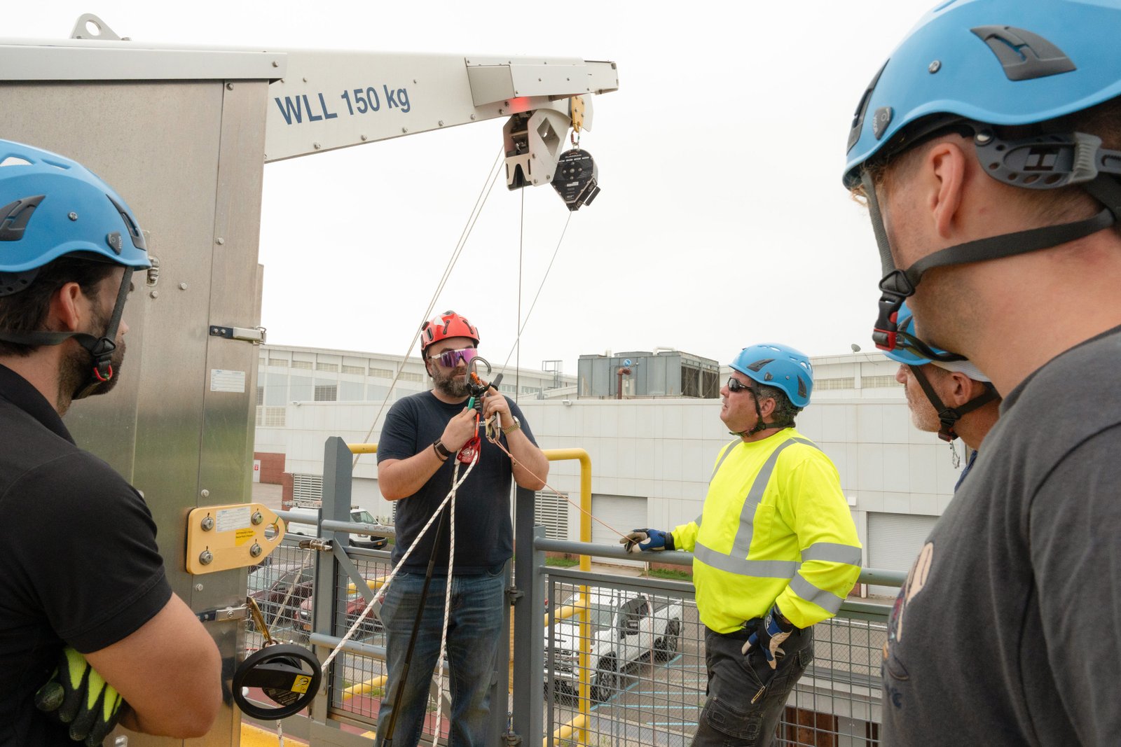 Men in hard hats stand around talking