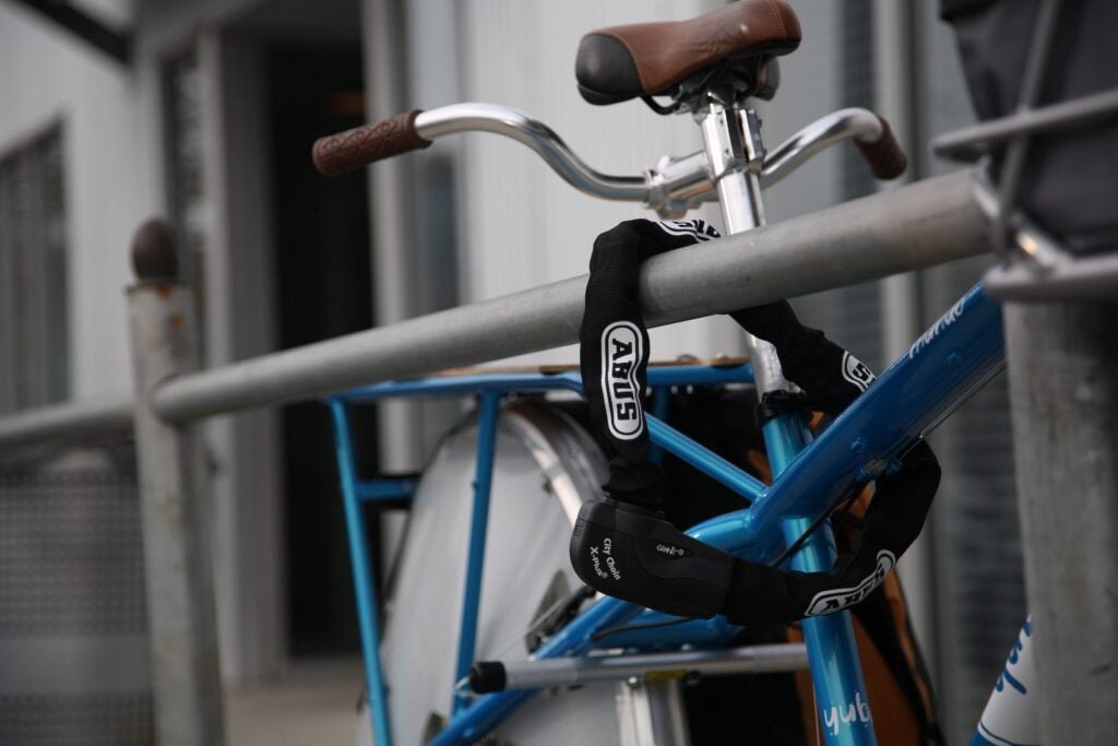 The 5 Best eBike Locks on Amazon (Thieves Hate These) 17 ABUS Granit CityChain XPlus 1060 chain lock securing a bike