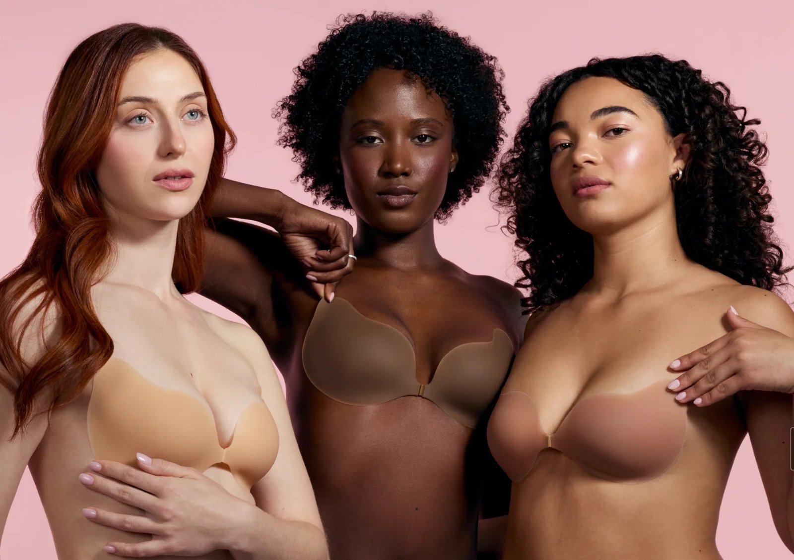 Three women wearing strapless adhesive bras in different skin tones pose against a pink background, showcasing perfect style inspiration just in time for our Labor Day Sale.