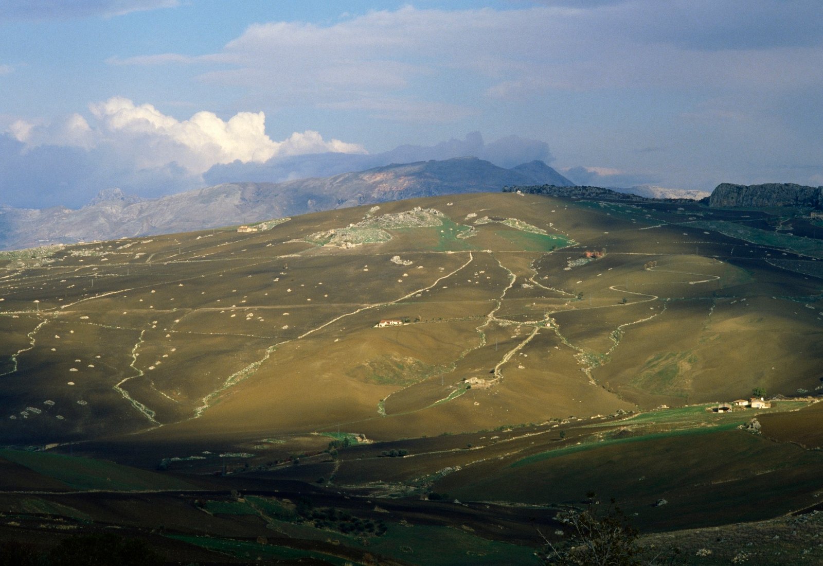 clouds and farms of a picturesque hillside