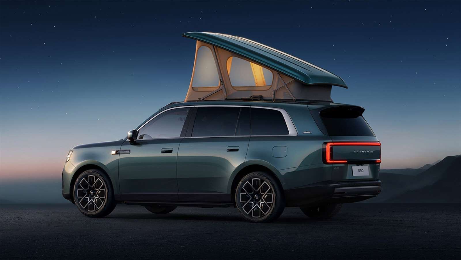 Rear three-quarter view of a Xiaomi Sky Nomad N90 Max Explorer edition at dusk, with its pop-top roof raised and illuminated.