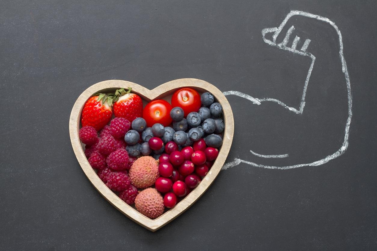 health diet heart abstract concept with strong man hand on blackboard