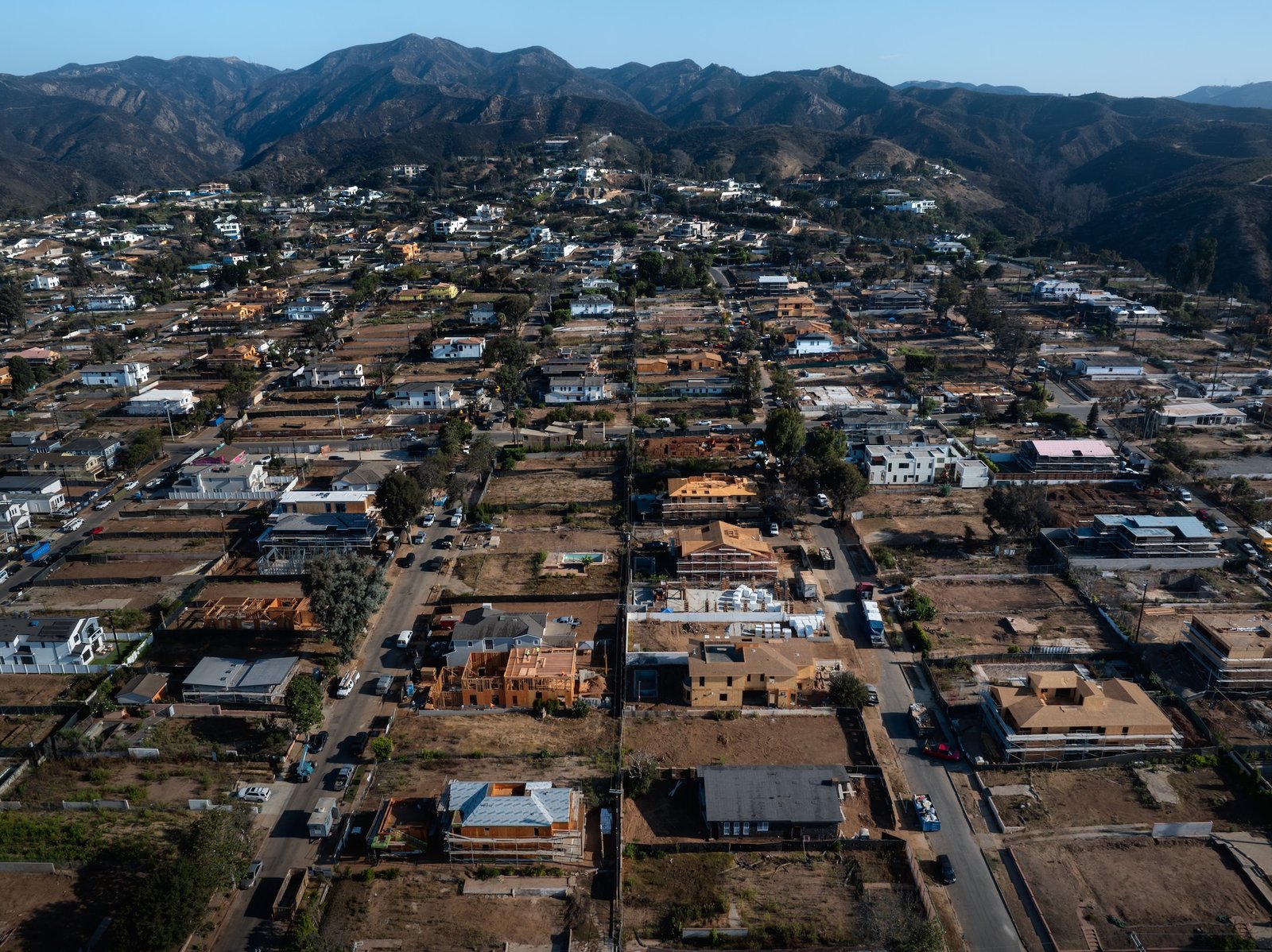 An aerial view of burned and partially reubuilt houses in California