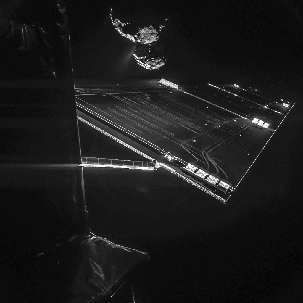 Image of a Rosetta spacecraft solar array in foreground and the nucleus of comet 67P in background.