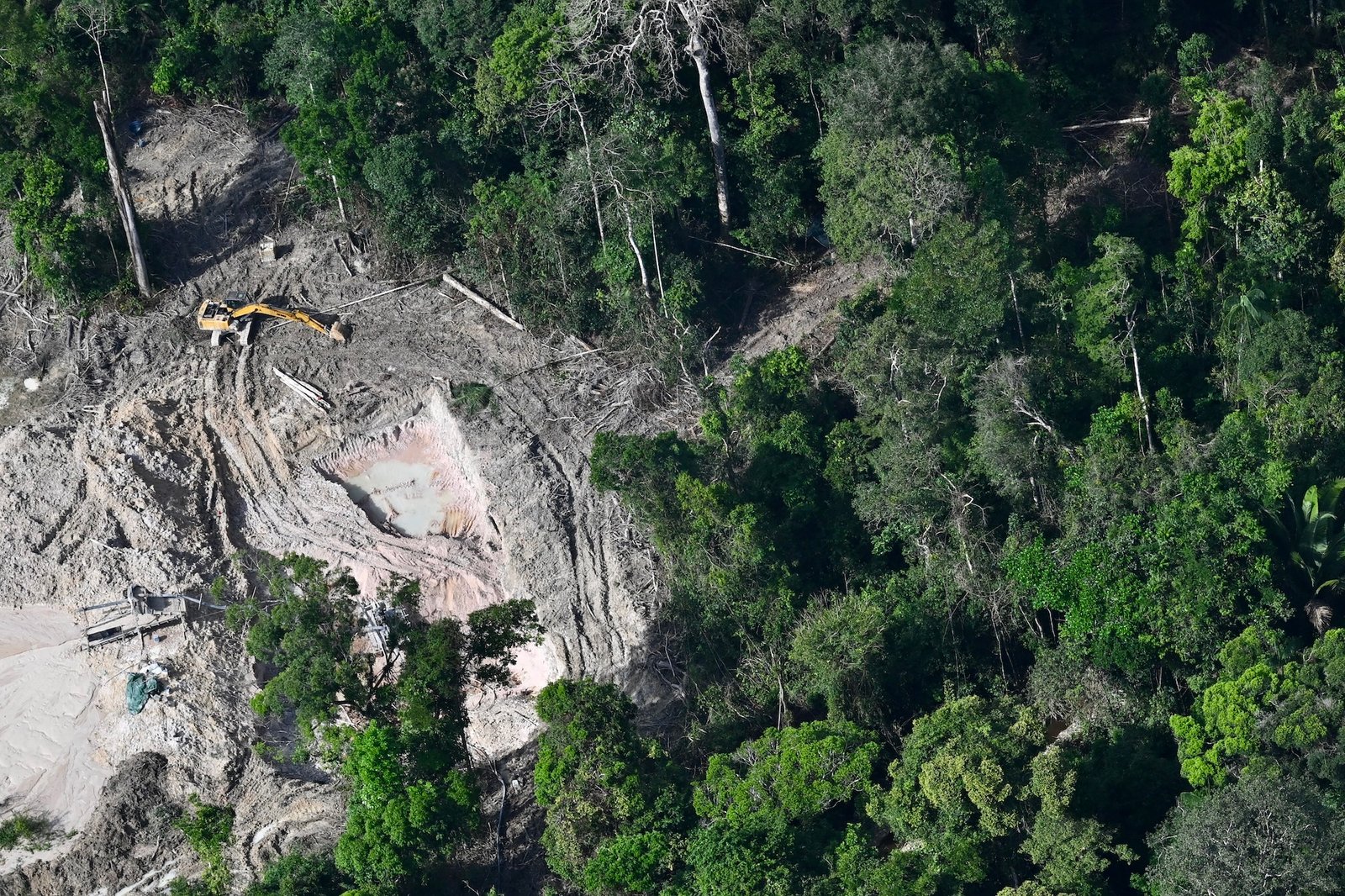 A backhoe near a cleared part of the Amazon rainforest