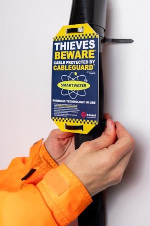 CableGuard protective sleeve fitted around an EV charging cable, with a warning tag stating that the cable is protected by CableGuard and SmartWater