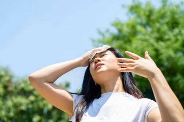 a woman hot outside in the sun