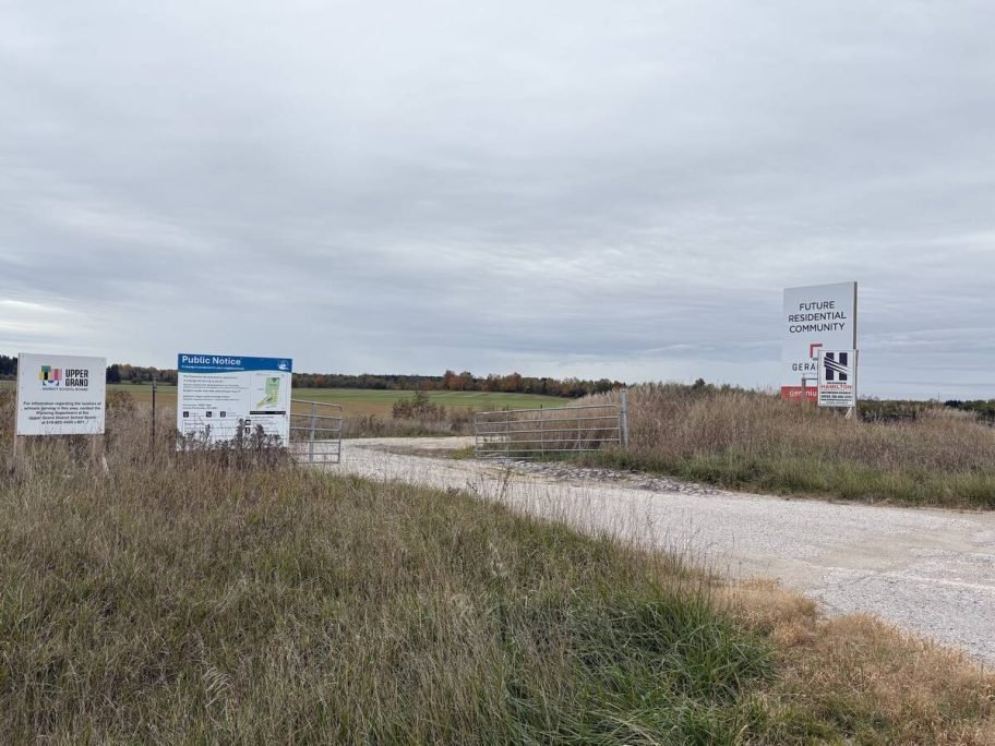 Signs mark the gated entrance to the former golf course property, with farmland beyond. Photo: Sarah McGoldrick