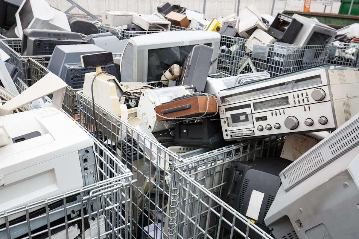 Computer monitors and other discarded electronic equipment piled in collection baskets