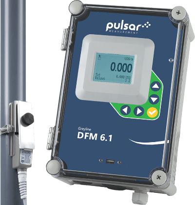 Pulsar Measurement Greyline DFM 6.1 flow meter with digital display and control buttons, mounted alongside a pipe.