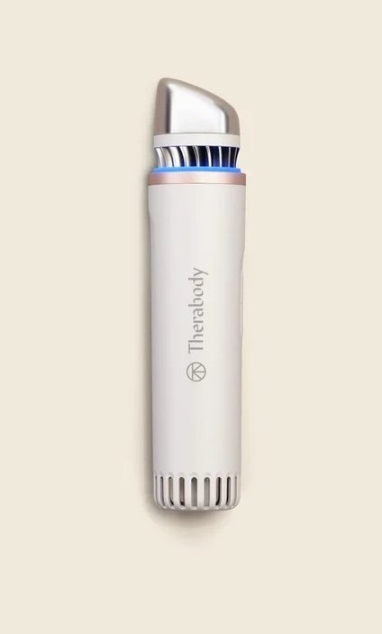A vertical Therabody TheraFace mask device in white and silver.