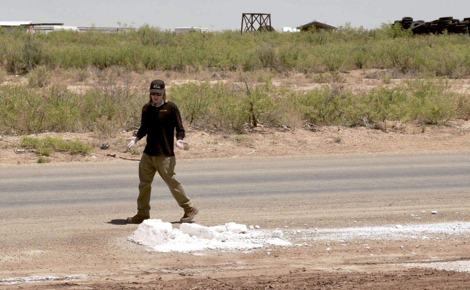 A man walks on a rural road
