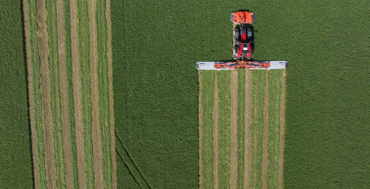 This overhead shot shows the Kuhn GMD 15030 rear mounted quad disc mower in a field.