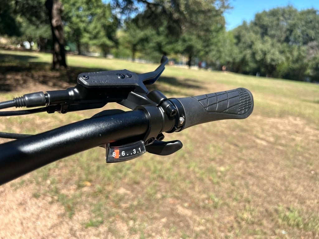 Lectric XPress Lite handlebar with the Shimano 8-speed trigger shifter and left-side thumb throttle