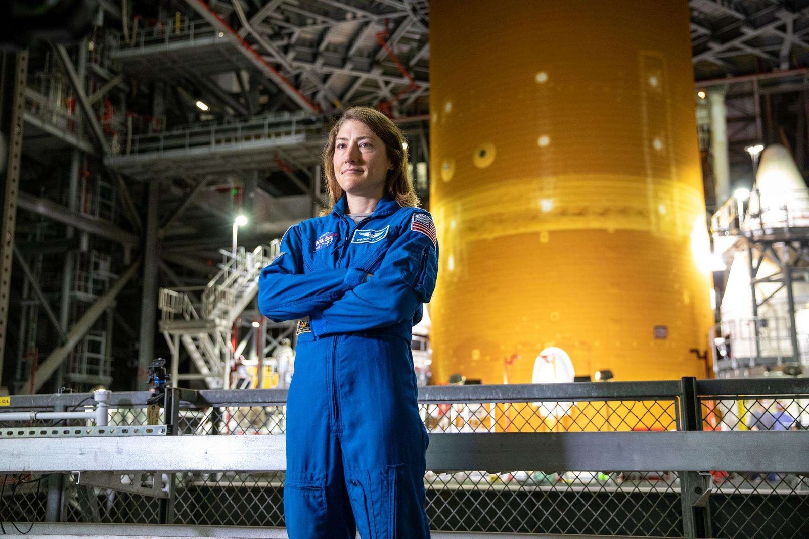 NASA astronaut Christina Koch stands inside Kennedy Space Center’s Vehicle Assembly Building on July 14, 2021, in front of the agency’s Space Launch System (SLS) rocket that ultimately powered the Orion spacecraft on the Artemis I mission. Koch later served as a crew member on the Artemis II mission in 2026, and on Oct. 13, 2026, NASA announced she will serve next as the agency’s acting deputy chief engineer.