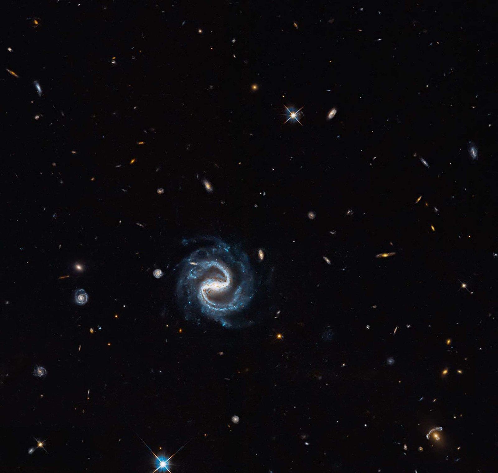 A spiral galaxy with two distinct arms forming a backwards