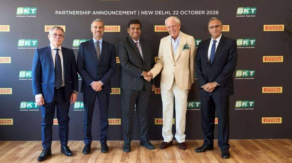 Representatives of Pirelli and BKT stand on stage to mark the signing of the agreement.