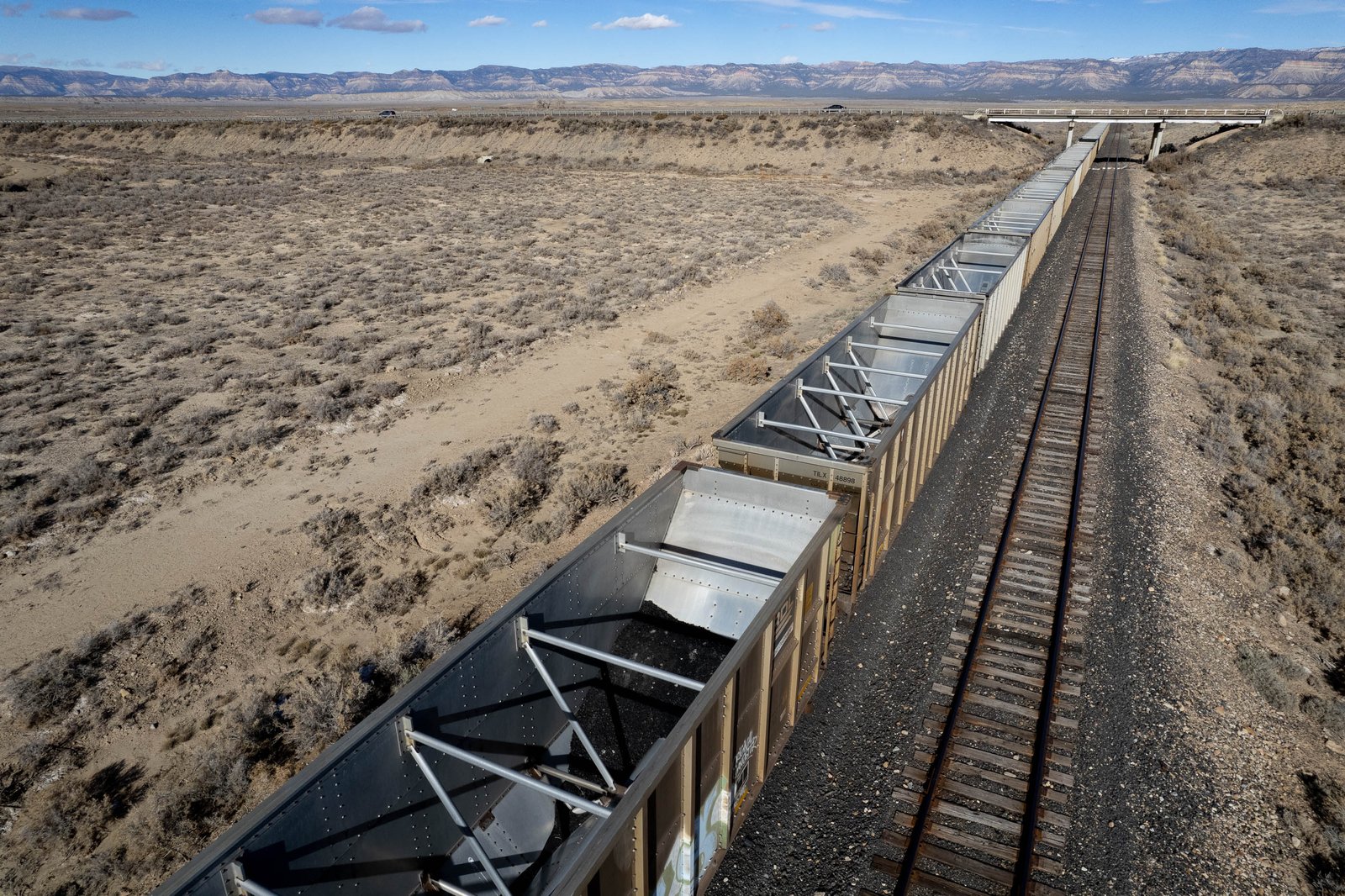 Empty coal cars sit idle against a desolate landscape in Carbon County, Utah.