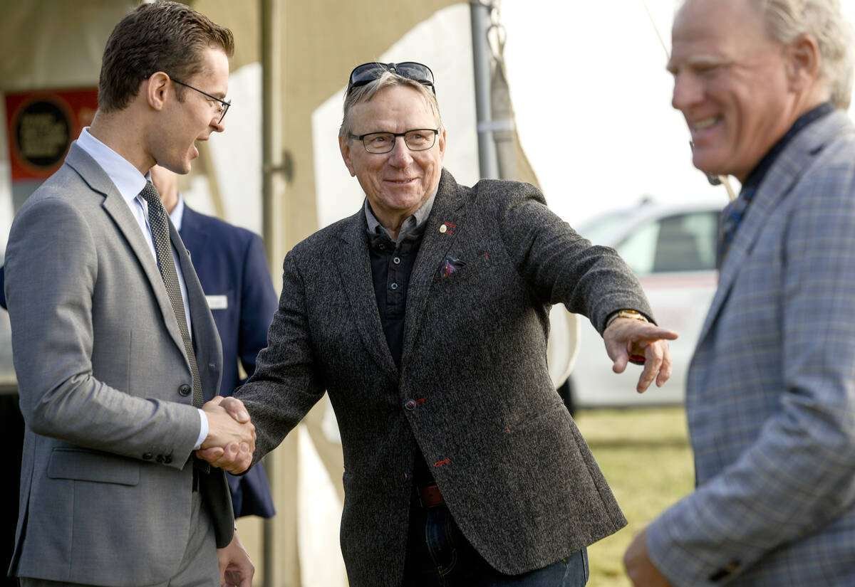 Minister of Agriculture, Food and Agribusiness, Sam Oosterhoff, left, and William Bearss, chair of the Ontario Broiler Hatching Egg and Chick Commissions, shake hands while sharing a joke with Scott Helps, chair of Egg Farmers of Ontario, far right, at the Ontario Poultry Research Centre sod turning at the Elora Research Station grounds. Photo: Diana Martin