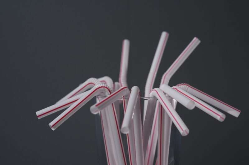 Plastic straws are displayed in a glass, Tuesday, Feb. 11, 2025, in Cincinnati. (AP Photo/Joshua A. Bickel)