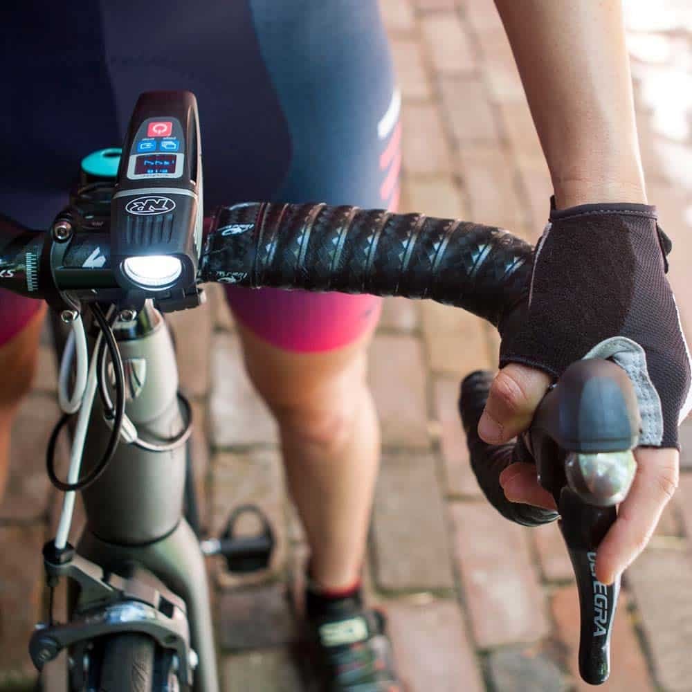 NiteRider Lumina OLED 1200 Boost headlight with its runtime screen on a road bike handlebar