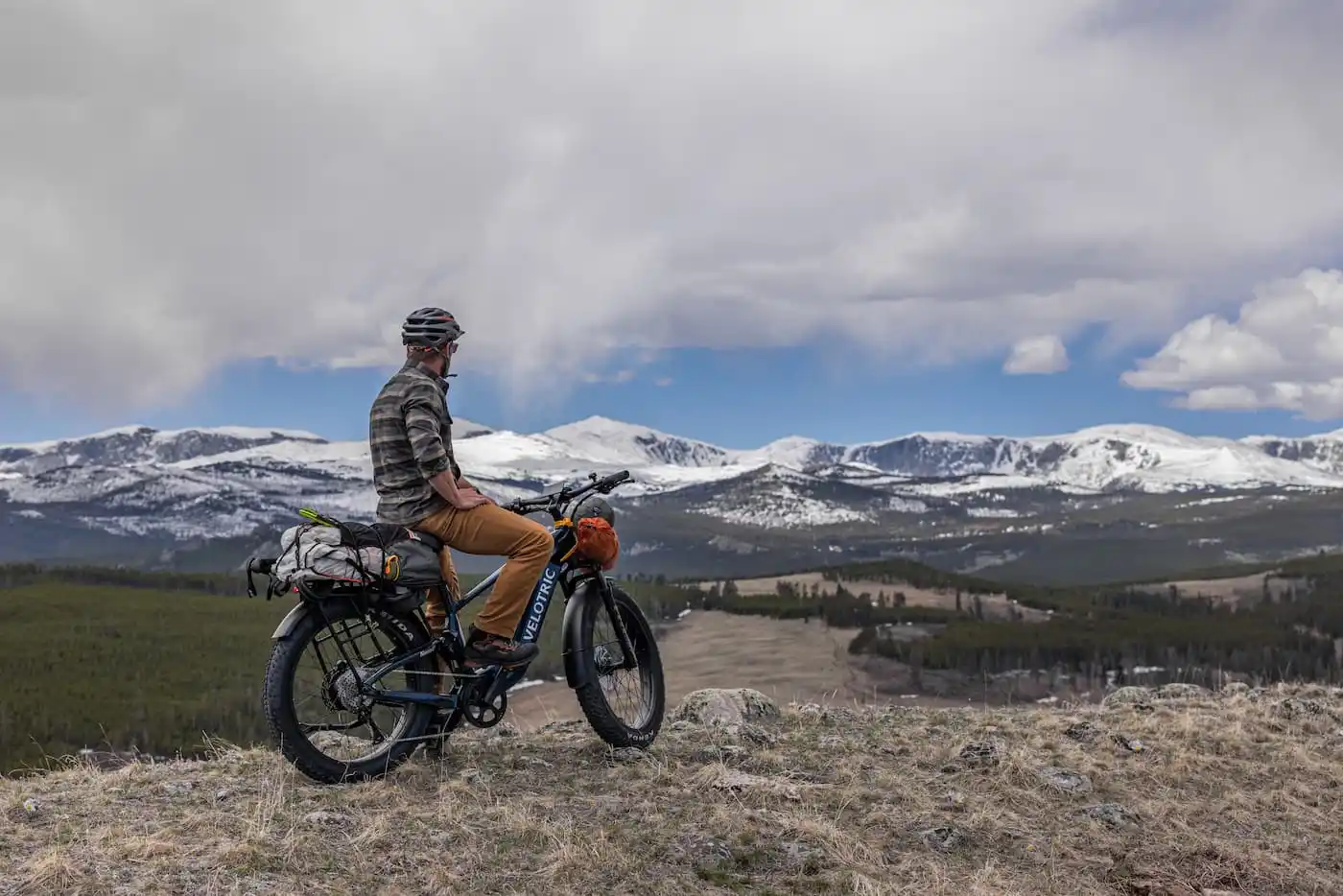 Rider on a Velotric Nomad 2X fat tire ebike looking out at snowy mountains