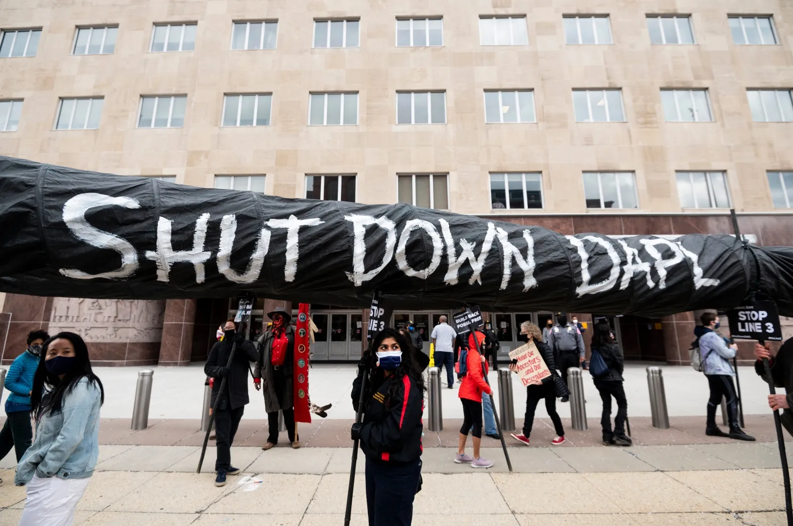 Indigenous youth and climate activists hold a protest against pipeline projects in Washington, DC, in 2021. A new bipartisan permitting reform bill in the Senate would make it easier to build many pipelines.