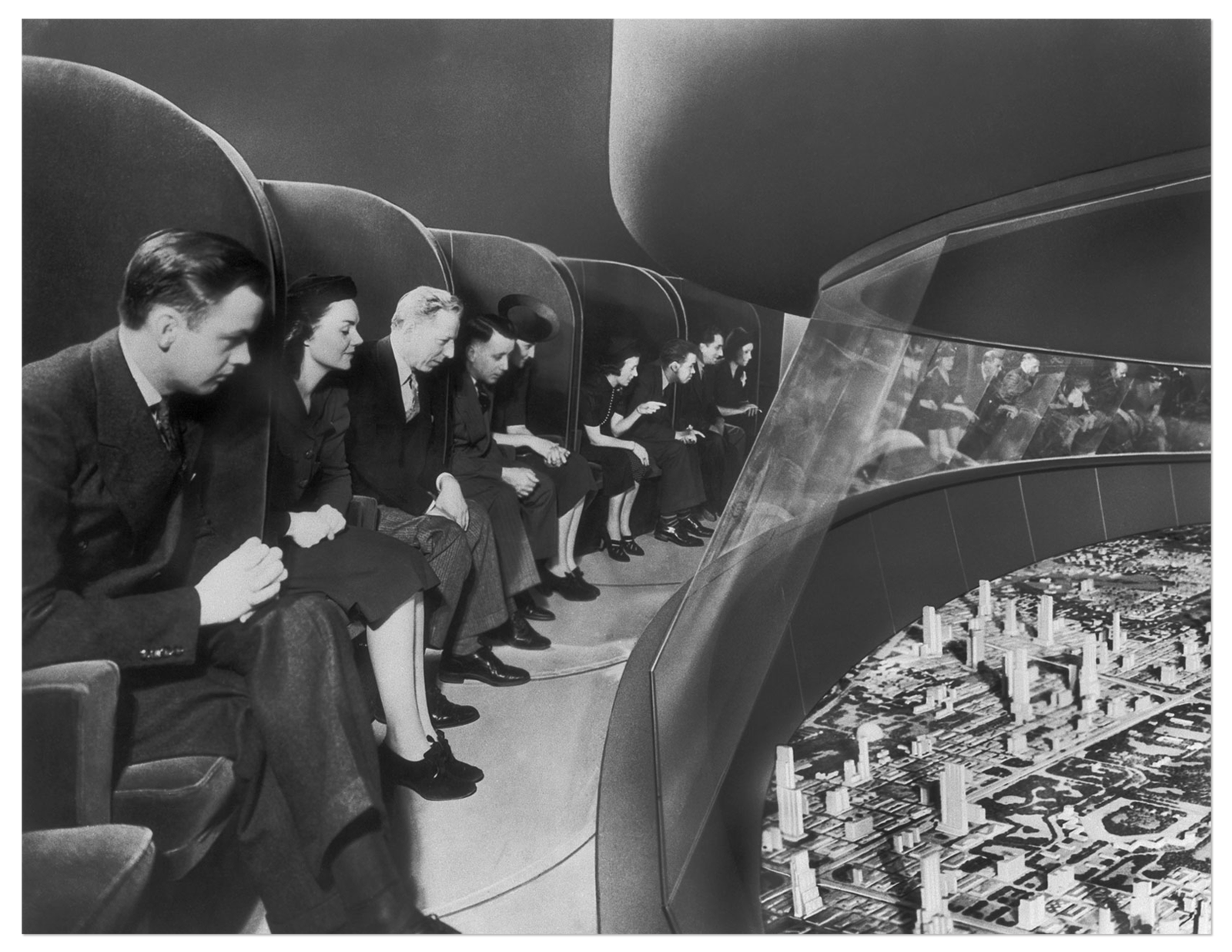 Photo of people peering over at a futuristic model city below