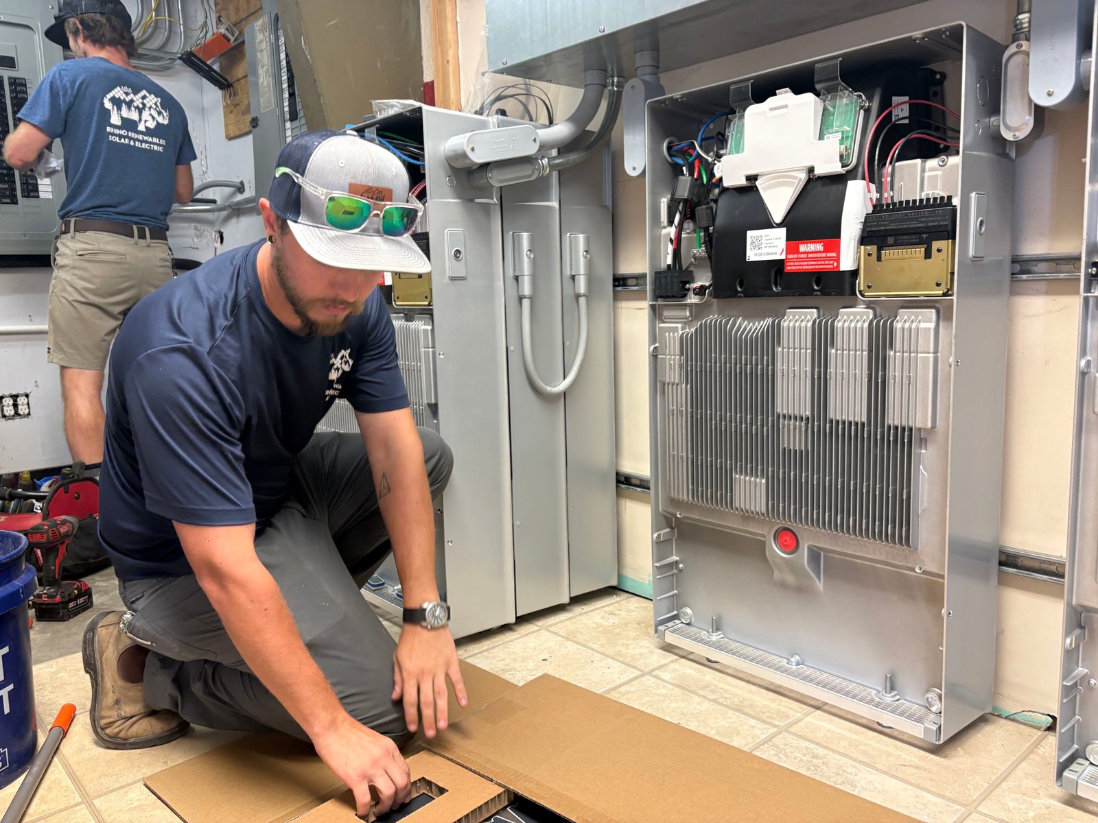 two men work on battery installation