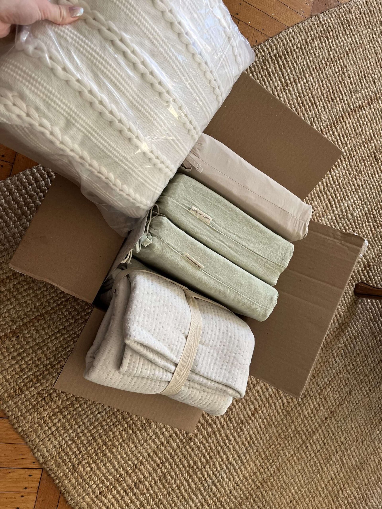 The writer unboxing her bedding from Under the Canopy.